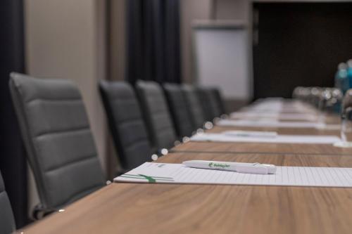 a long table in a conference room with chairs at Holiday Inn - Hamburg - Berliner Tor by IHG in Hamburg