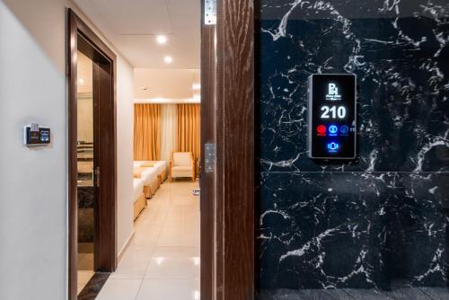 a clock on the wall of a hallway with a room at Petra Elite Hotel in Wadi Musa