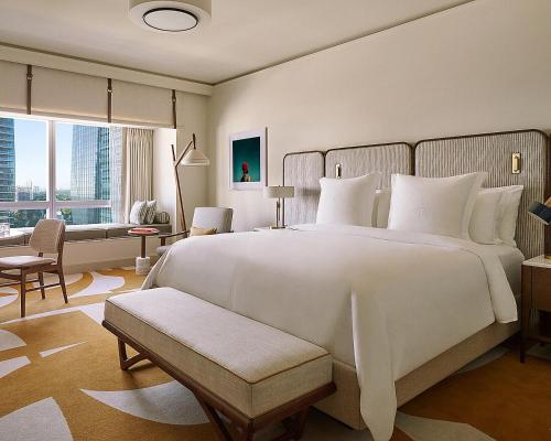 a bedroom with a large white bed and a large window at Four Seasons Hotel Miami in Miami