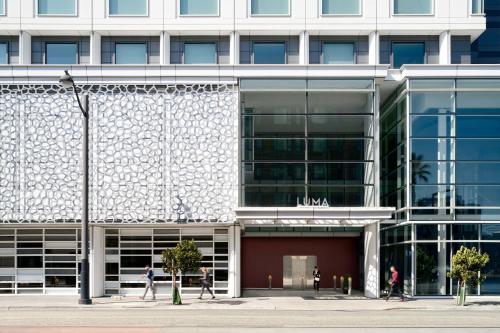 a building with people walking in front of it at LUMA Hotel San Francisco in San Francisco