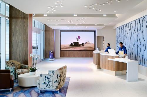 a rendering of a lobby with people working at computers at LUMA Hotel San Francisco in San Francisco