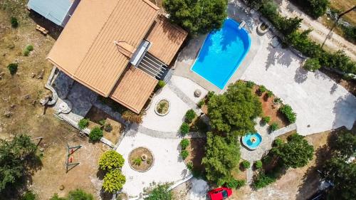an overhead view of a house with a swimming pool at Elatia Villa in Volimes