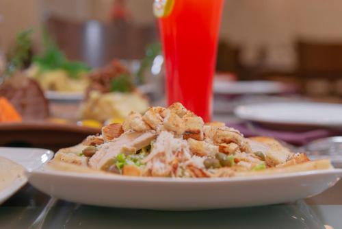 a plate of food on a table with a plate of food at Petra Elite Hotel in Wadi Musa