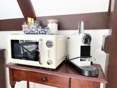 a microwave sitting on top of a wooden table at Flinder Amsterdam in Amsterdam