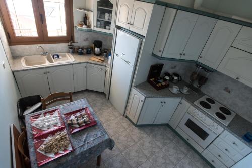 an overhead view of a kitchen with a table and refrigerator at Artemis in Karpenisi