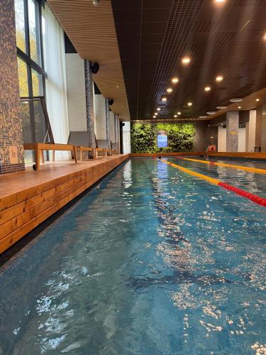an empty swimming pool in a large building at Albatross Beach Apartment - SPA, Sea and Forest in Ķesterciems
