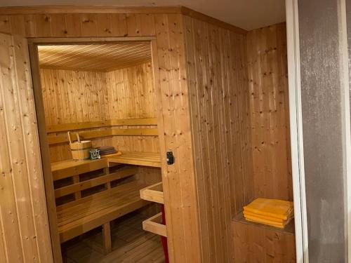 an empty sauna with wooden walls and wooden shelves at Haus Kreuzboden in Hundsdorf