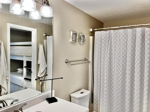 a bathroom with a shower curtain and a toilet at Cabana's @ Gulf Place #308 in Santa Rosa Beach