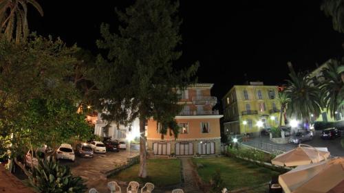a house with cars parked in a parking lot at night at Hotel Villa Maria in Sanremo