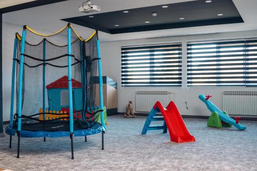 a play room with several different types of playground equipment at Hotel Forest in Pale