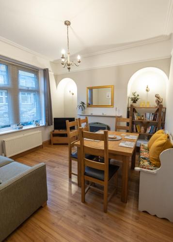 a dining room and living room with a table and chairs at Skipton at Six in Skipton