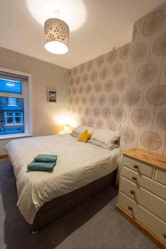 a bedroom with a large bed and a night stand at Skipton at Six in Skipton