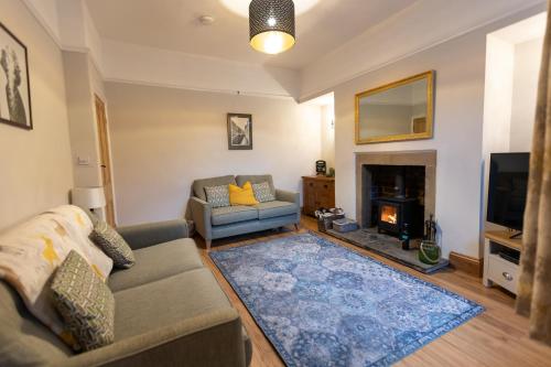 a living room with a couch and a fireplace at Skipton at Six in Skipton