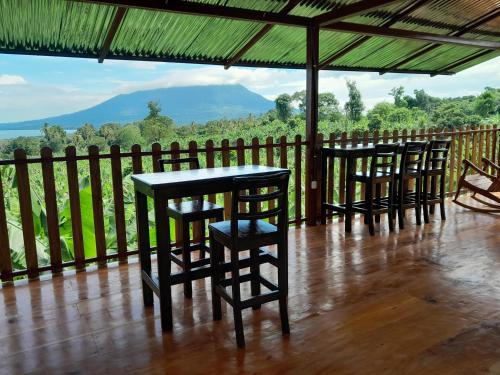 a row of chairs and a table on a balcony at Hostal Bullshark in Cuatro Esquinas