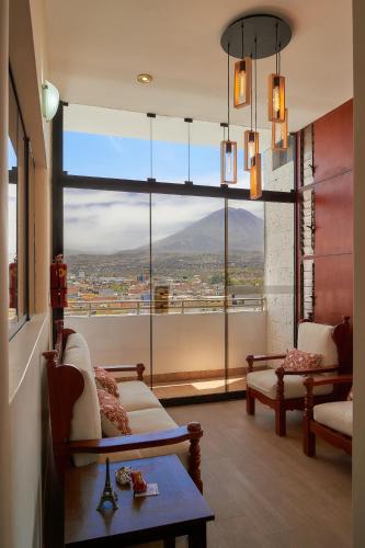 a living room with a large window with a view at Natura Inn Hotel in Arequipa