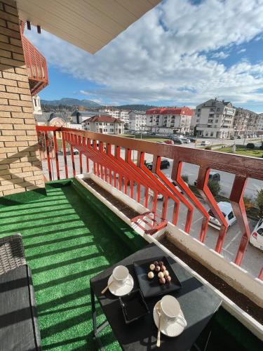 a balcony with a table and a view of a city at President Lux Apartment in Pale