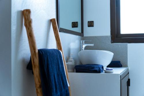 a bathroom with a sink and a bowl on a counter at ChezBabo Wellness Hotel in Ngaparou