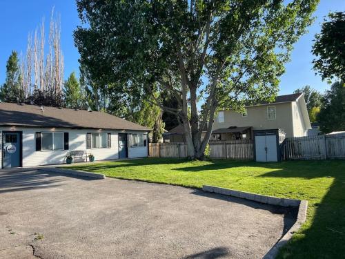a house with a tree and a driveway at Guest Suites 1996 #2 - Fresh 1 bedroom 1 bath Suite in Idaho Falls