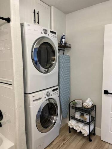 a washing machine and a washer in a bathroom at Guest Suites 1996 #2 - Fresh 1 bedroom 1 bath Suite in Idaho Falls