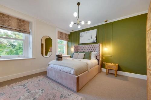 a bedroom with green walls and a bed and a window at Newly renovated 4 Bedroom Cottage with Wood Burner in Aysgarth