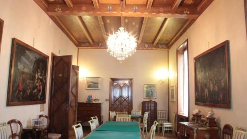a dining room with a table and a chandelier at Hotel Villa Maria in Sanremo