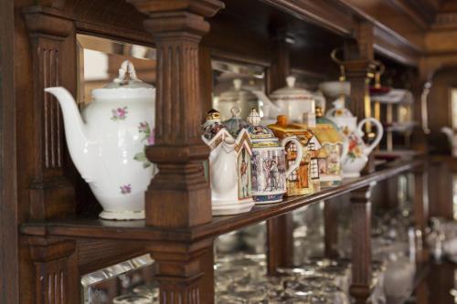 a shelf with a bunch of vases on it at Hotel Vierhouten in Vierhouten