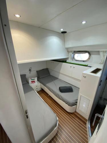 a small cabin on a boat with a bed at Barco muy romantico con parking! in Barcelona