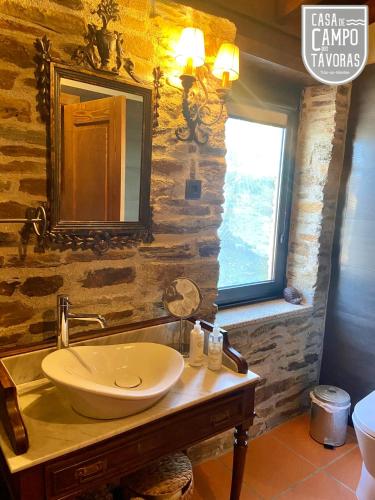 a bathroom with a sink and a mirror at Casa de Campo dos Távoras in Mirandela