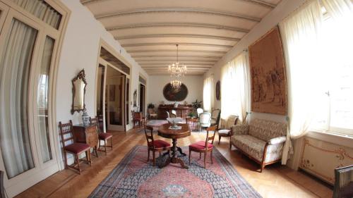 a living room with a table and chairs at Hotel Villa Maria in Sanremo
