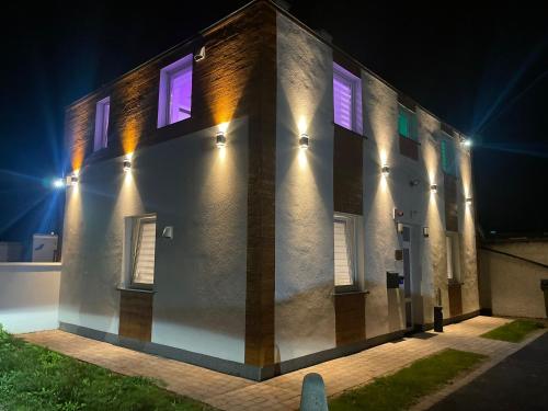 a building with lights on the side of it at night at #2 TGHA Luxury Studio Apartment in Athlone in Athlone