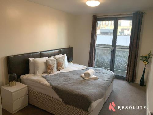 a bedroom with a bed with a hat on it at New Renovated Arcadian Centre - One Bedroom - Balcony - Sofa Bed in Birmingham