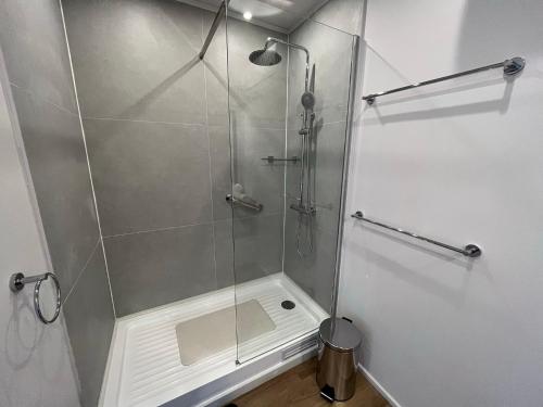a bathroom with a shower with a glass door at La Petite France in San José de Maipo