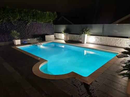 a swimming pool in a backyard at night at !Chalet de lujo para vacaciones!... in Camargo