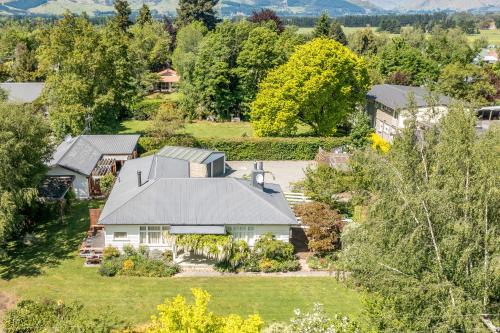 an aerial view of a house with a garden at Harrogate Gardens Motel in Hanmer Springs