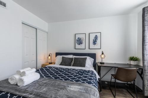 a bedroom with a bed and a desk with a desk at Marbella Lane - Neat and Cozy Modern Home in East Palo Alto
