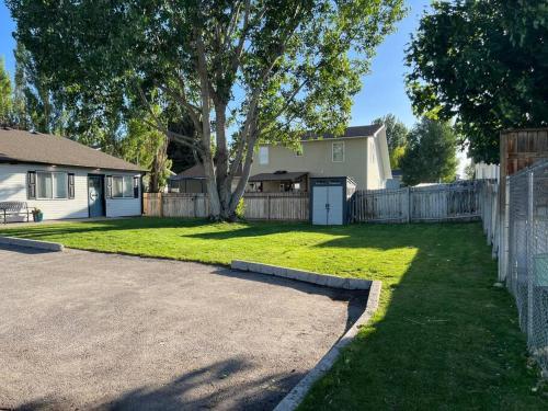 a yard with a fence and a house at Guest Suites 1996 #4- Relaxing 1 bedroom 1 bath Suite in Idaho Falls