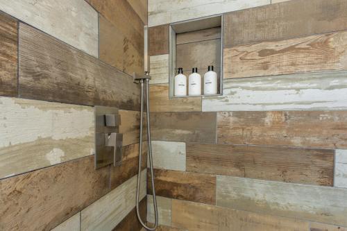 a bathroom with a shower with two shampoo bottles at Marbella Lane - Neat and Cozy Modern Home in East Palo Alto