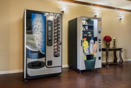 two refrigerators are standing next to each other at Knights Inn College Station in College Station