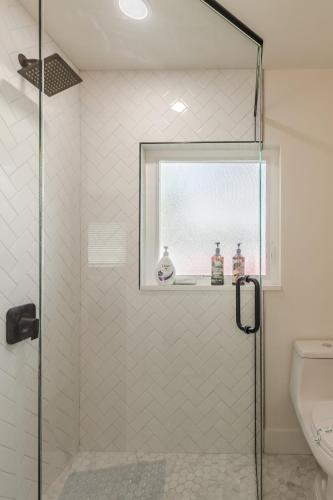 a bathroom with a glass shower with a toilet at Luxury Tiny Home 2 Miles from Downtown Orlando in Orlando
