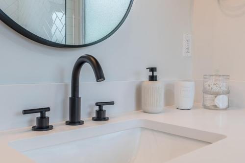 a bathroom sink with a mirror above it at Luxury Tiny Home 2 Miles from Downtown Orlando in Orlando