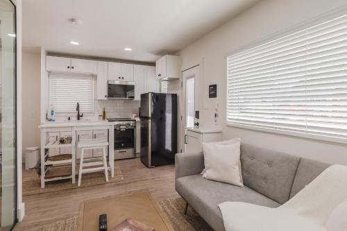 a living room with a couch and a kitchen at Luxury Tiny Home 2 Miles from Downtown Orlando in Orlando