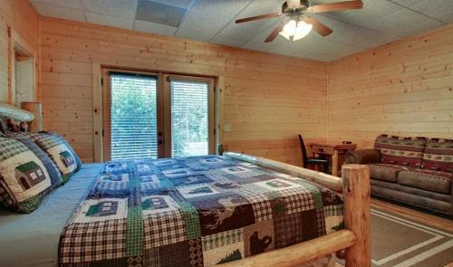 a bedroom with a bed and a ceiling fan at Astounding River View in Copperhill