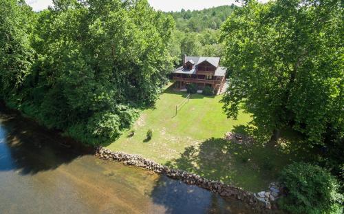 an aerial view of a house in the middle of a river at Astounding River View in Copperhill