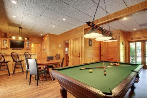 a billiard room with a pool table and a dining room at Astounding River View in Copperhill
