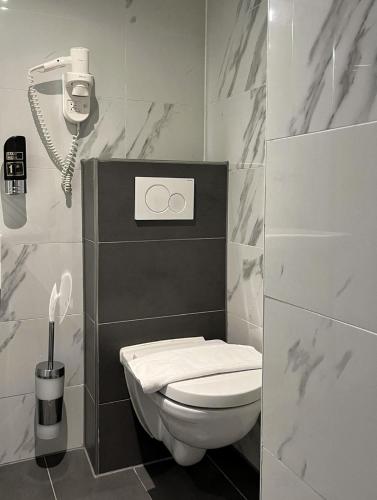 a bathroom with a toilet and a phone at Facade Hotel Amsterdam in Amsterdam