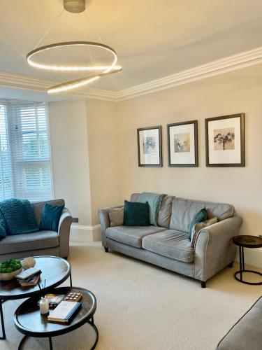 a living room with a couch and a table at Edge Mere Apartment, Bowness-on-Windermere in Bowness-on-Windermere