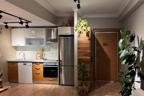 a kitchen with white appliances and a wooden floor at The Luxury of Life With a Feeling of Nature in Esenyurt