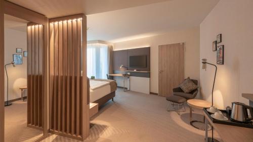 a hotel room with a bed and a television at Holiday Inn - Hamburg - Berliner Tor by IHG in Hamburg