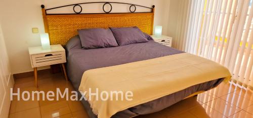 a bedroom with a large bed with two night stands at Villa Santa Ana 23 in Maspalomas