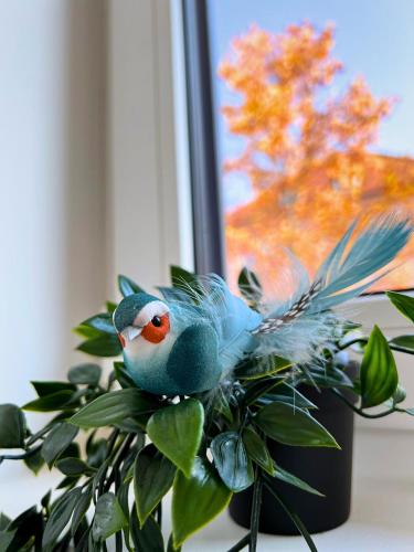 a bird toy sitting on top of a plant at Villa Riverside in Ljubljana